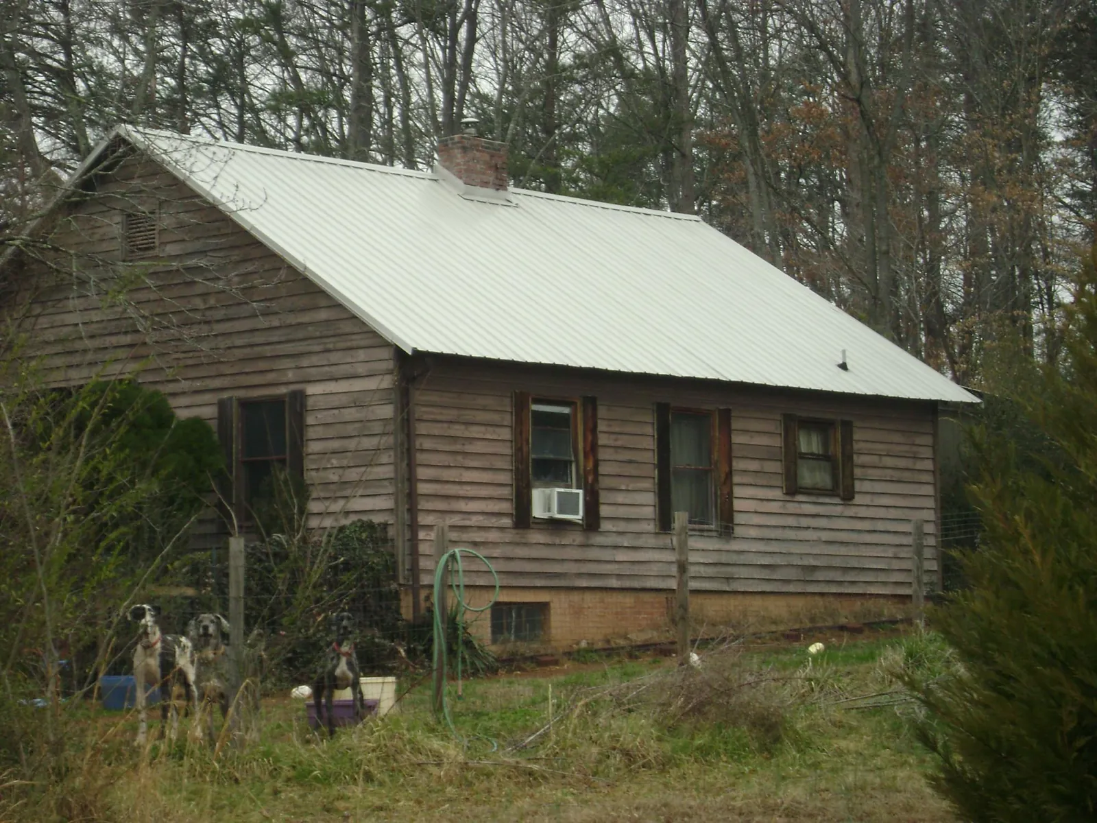 White metal roof on an old wood sided farmhouse, from a Metal Roof Installation job in Jasper